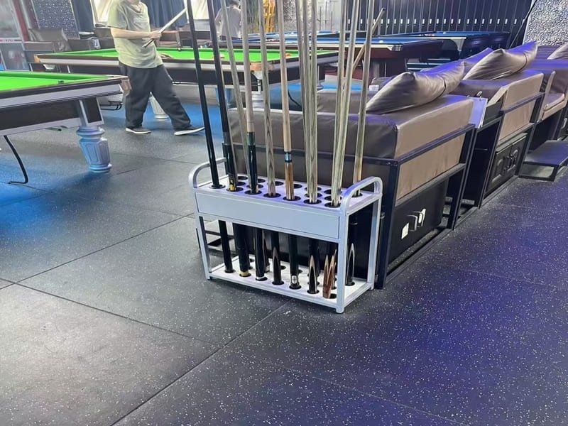 Close-up of a worn rubber tile showing granule shedding and surface cracking